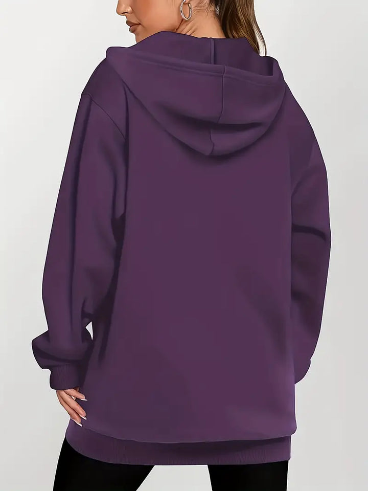 Angeleen – Bunda s kapucí, zipem a geometrickým potiskem.